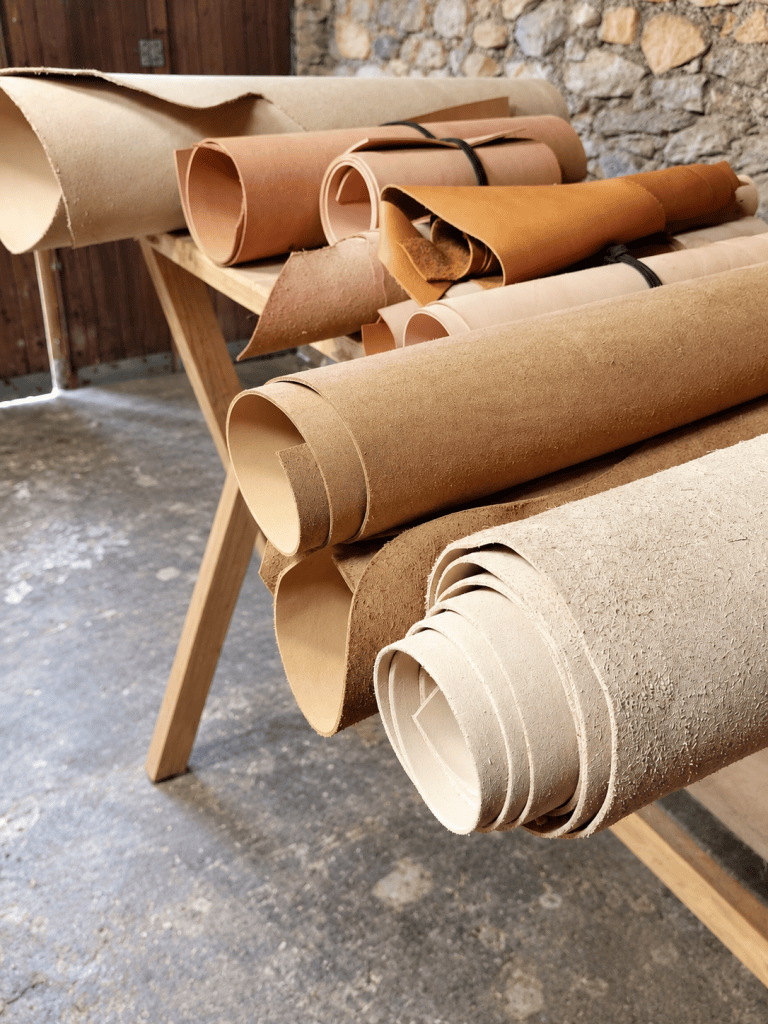 Rouleaux de cuir sur un support en bois dans l’atelier